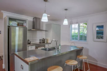 Fully equipped kitchen at Tinkerbell Cottage includes an island bench with built in sink
