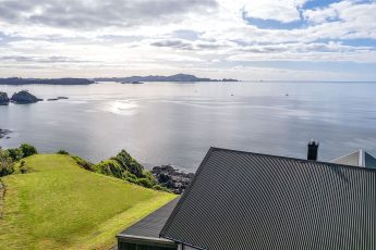 Aerial view overlooking clifftop lawn with bean bags - Ocean Cliff, Bay of Islands, New Zealand