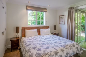 Downstairs master bedroom with french doors opening out to the garden at Capital Cottage